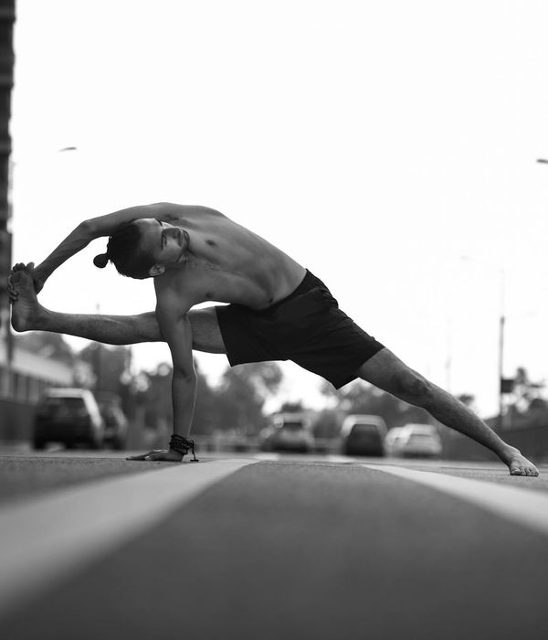 Male athlete in a focused yoga pose, demonstrating strength and balance.